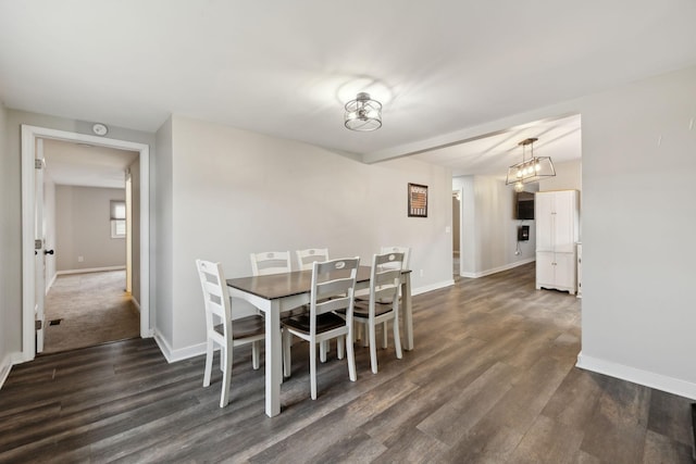 dining room with dark hardwood / wood-style flooring