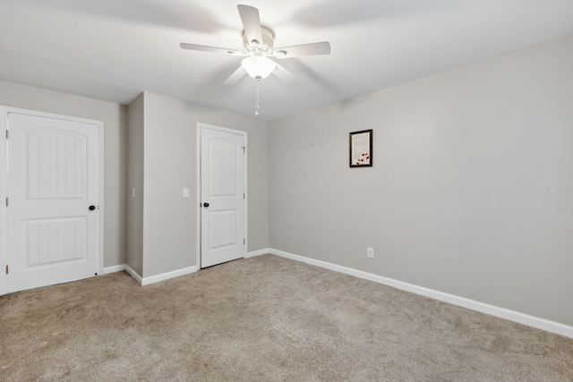 interior space featuring light colored carpet and ceiling fan