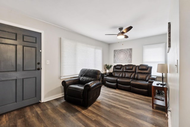 living room featuring plenty of natural light, dark wood-type flooring, and ceiling fan