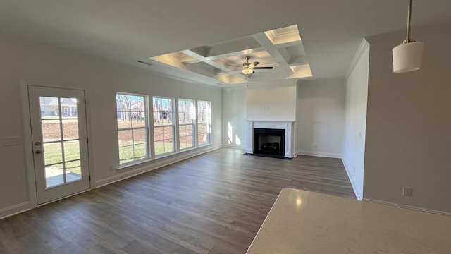 unfurnished living room featuring dark hardwood / wood-style floors, ornamental molding, coffered ceiling, ceiling fan, and beam ceiling