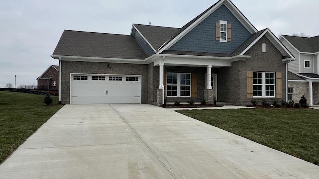 craftsman inspired home featuring a garage and a front yard