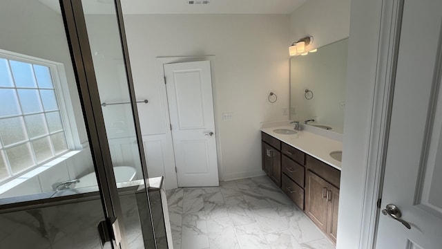 bathroom with vanity and a tub