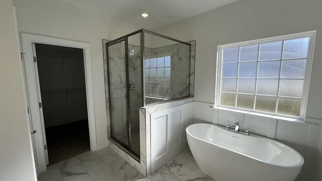 bathroom featuring shower with separate bathtub