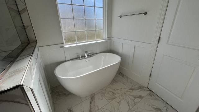 bathroom with a tub to relax in