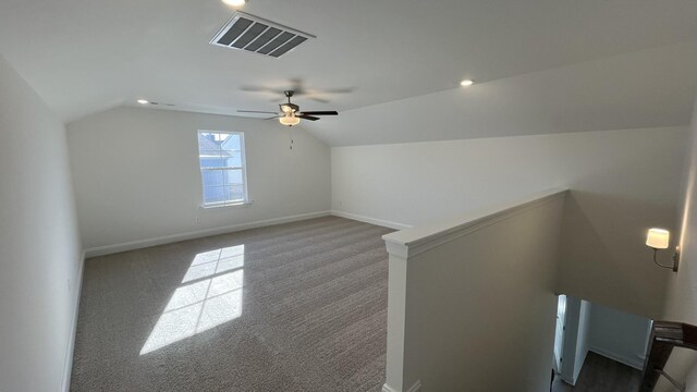 additional living space featuring vaulted ceiling, ceiling fan, and carpet floors