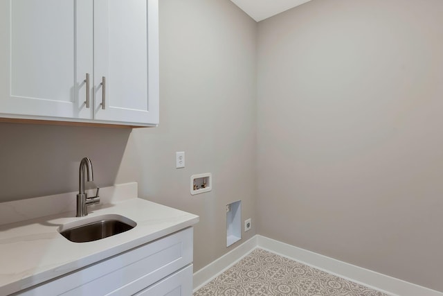 clothes washing area with hookup for a washing machine, electric dryer hookup, sink, and cabinets