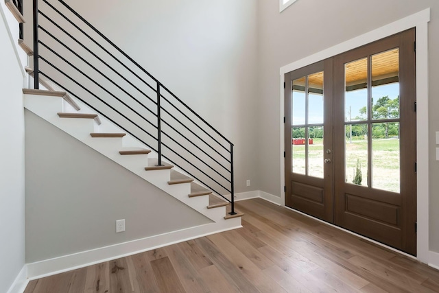 entrance foyer with french doors and hardwood / wood-style floors