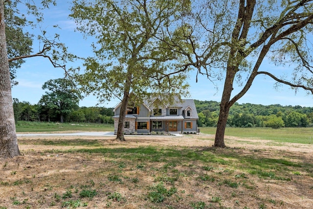 view of front of property with a front yard and a porch