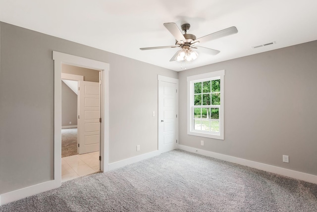 unfurnished bedroom with light colored carpet and ceiling fan