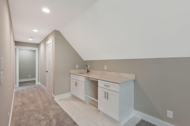 bathroom featuring sink and vaulted ceiling