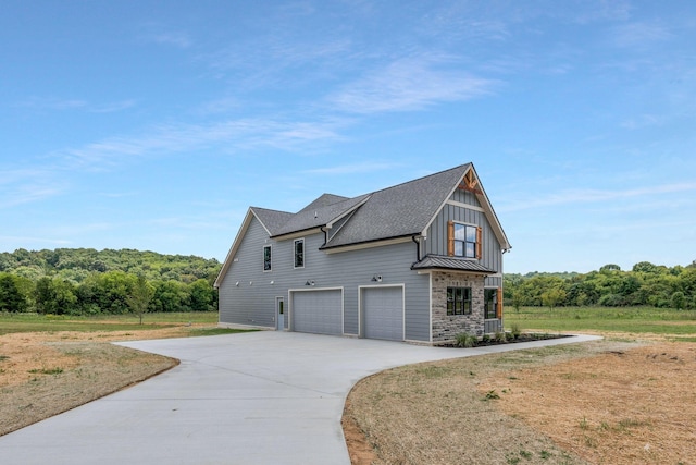 view of side of property featuring a garage and a yard