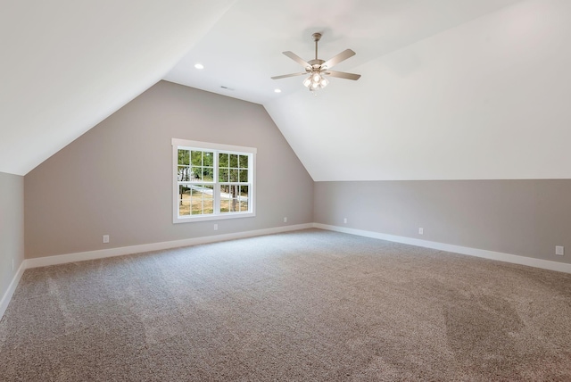 additional living space with ceiling fan, lofted ceiling, and carpet