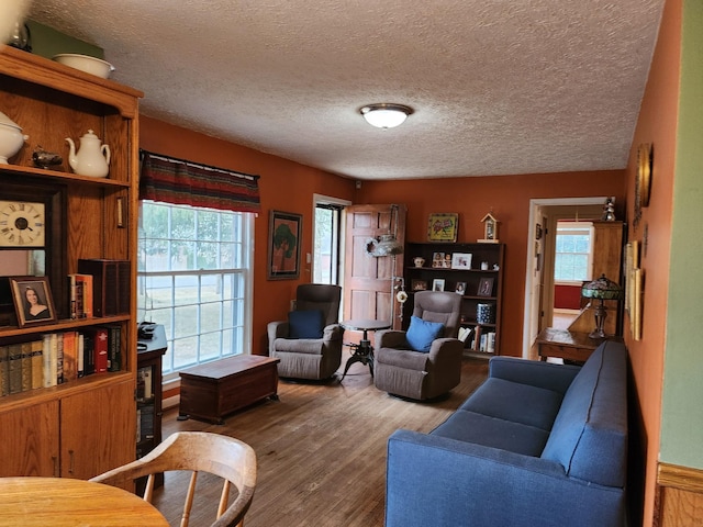 living room featuring hardwood / wood-style flooring, a healthy amount of sunlight, and a textured ceiling