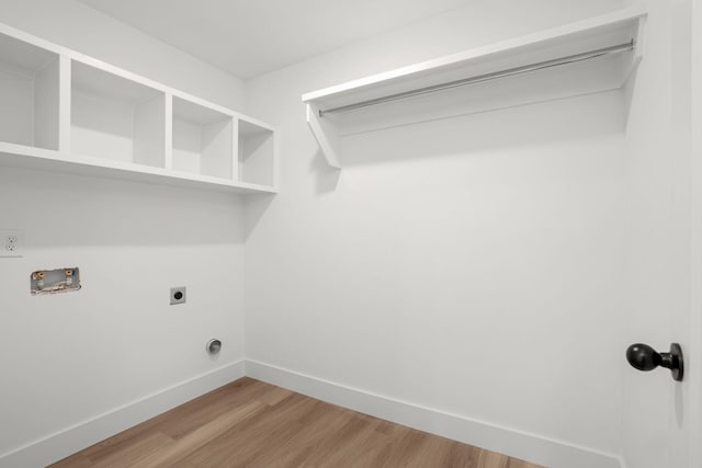 clothes washing area featuring hardwood / wood-style flooring, washer hookup, and hookup for an electric dryer