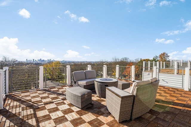 view of patio / terrace with a balcony and an outdoor living space with a fire pit