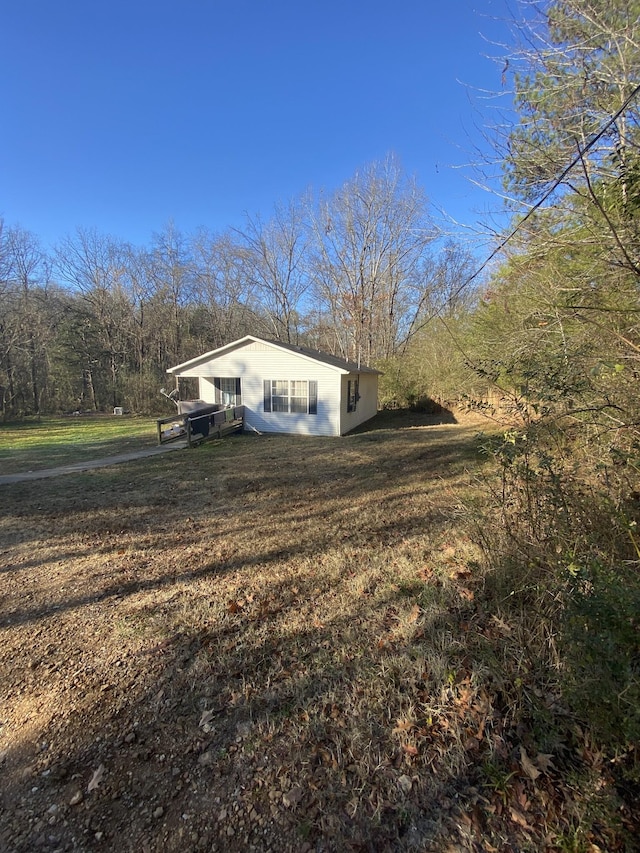 view of property exterior with a lawn