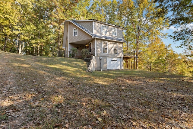 view of property exterior featuring a garage and a yard