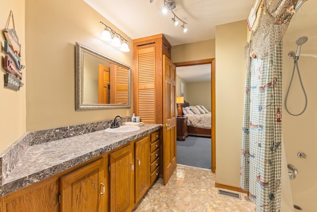 bathroom featuring vanity and walk in shower