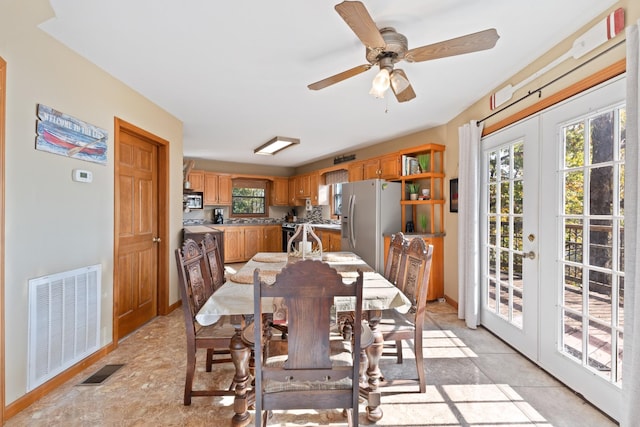 dining area featuring ceiling fan and french doors