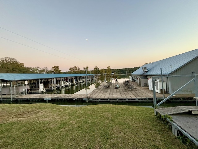 dock area featuring a yard and a water view