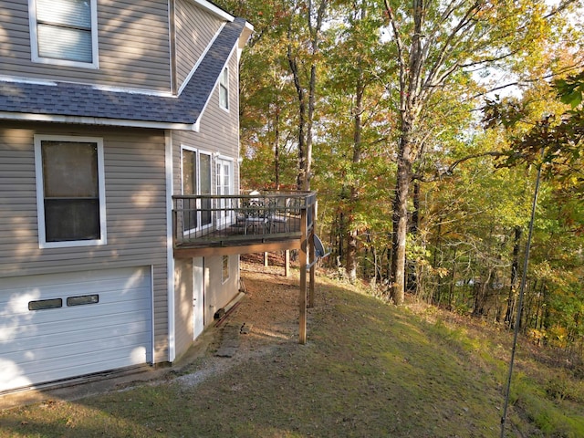 view of home's exterior with a garage and a deck