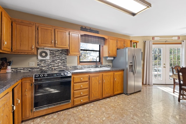 kitchen with french doors, sink, tasteful backsplash, stainless steel fridge with ice dispenser, and electric range oven