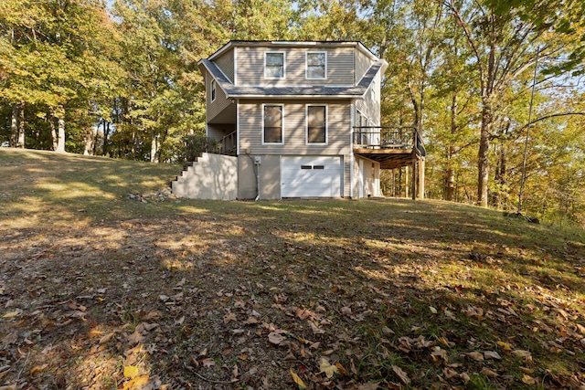 view of home's exterior featuring a yard, a garage, and a deck