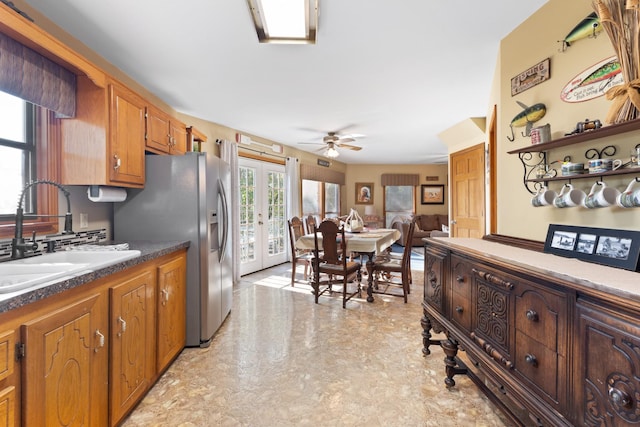 kitchen with french doors, ceiling fan, stainless steel fridge, and sink