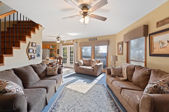 living room featuring ceiling fan and french doors