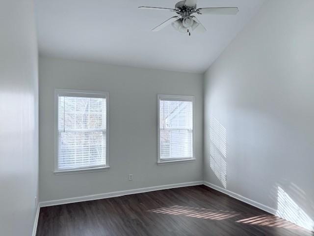 empty room with ceiling fan, lofted ceiling, and dark hardwood / wood-style floors