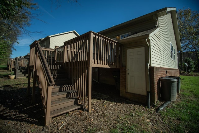 view of side of property with a wooden deck and central AC