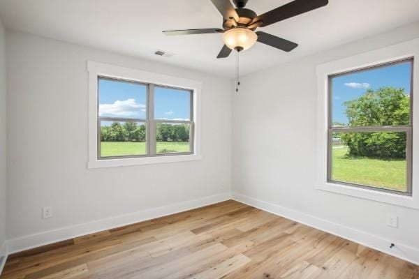 empty room featuring ceiling fan and light hardwood / wood-style floors