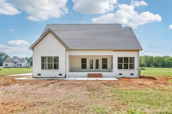 rear view of house with a yard and a patio area