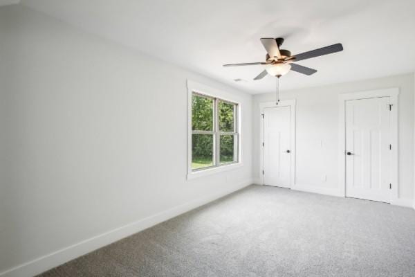 unfurnished bedroom featuring ceiling fan and carpet