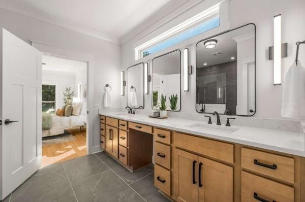 bathroom featuring crown molding, vanity, and a shower