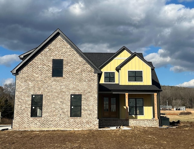 rear view of property with central AC