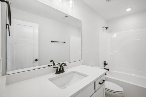 full bathroom featuring vanity, shower / washtub combination, and toilet