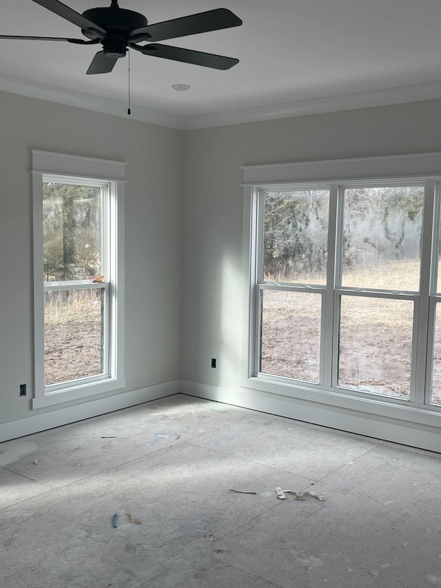 unfurnished room with ceiling fan, ornamental molding, and a wealth of natural light