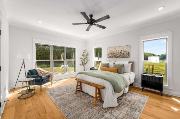 bedroom featuring wood-type flooring, ceiling fan, and crown molding