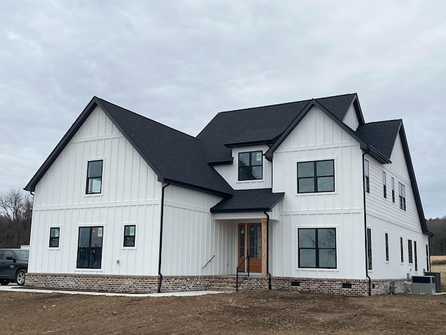 modern inspired farmhouse with crawl space, board and batten siding, and roof with shingles