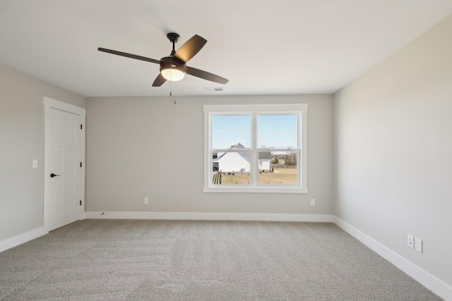 empty room featuring carpet floors and ceiling fan