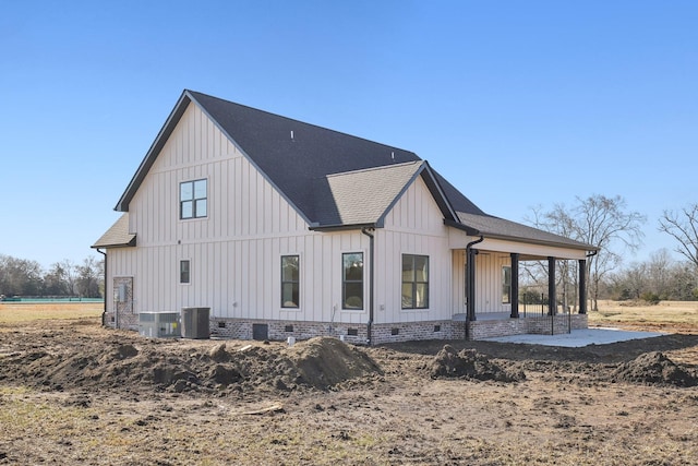 rear view of property with a porch and central air condition unit