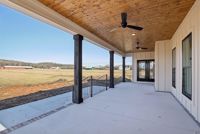 view of patio featuring a rural view, french doors, and ceiling fan