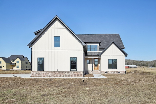 modern inspired farmhouse with a front lawn