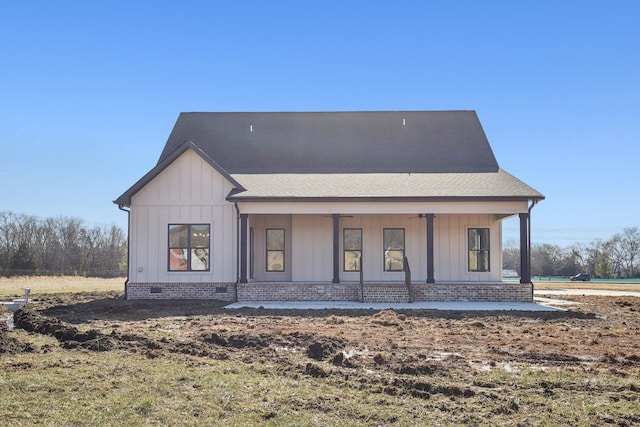 rear view of property featuring a porch