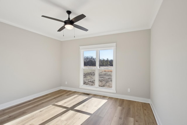 spare room featuring ceiling fan, ornamental molding, and light hardwood / wood-style floors