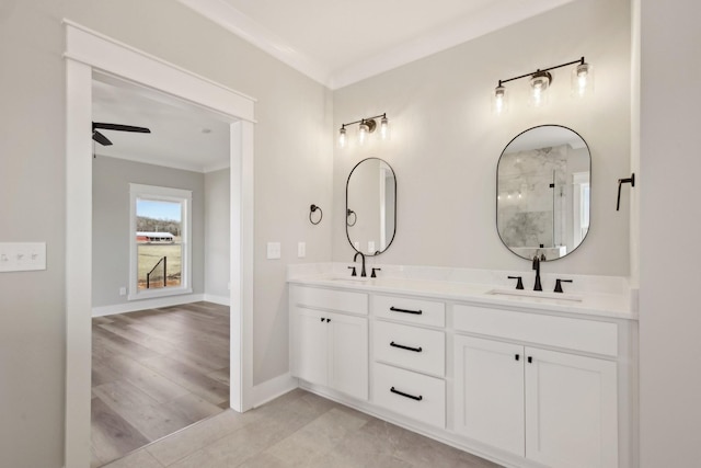 bathroom featuring vanity, ornamental molding, and ceiling fan