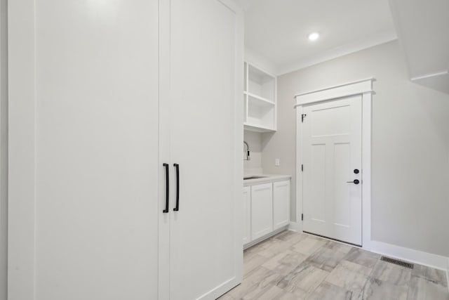 laundry room with sink and ornamental molding