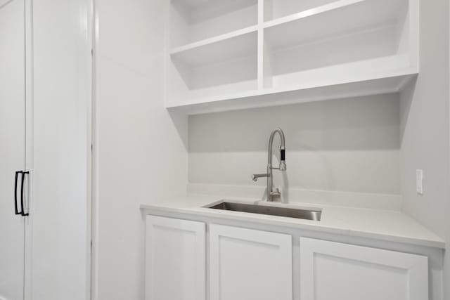 bar with sink and white cabinets