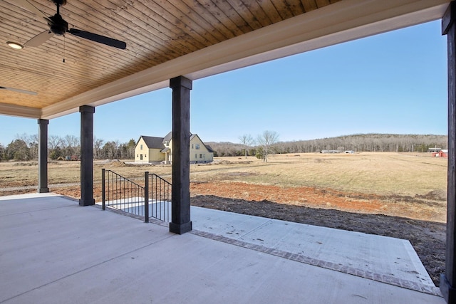 view of patio / terrace featuring a rural view and ceiling fan